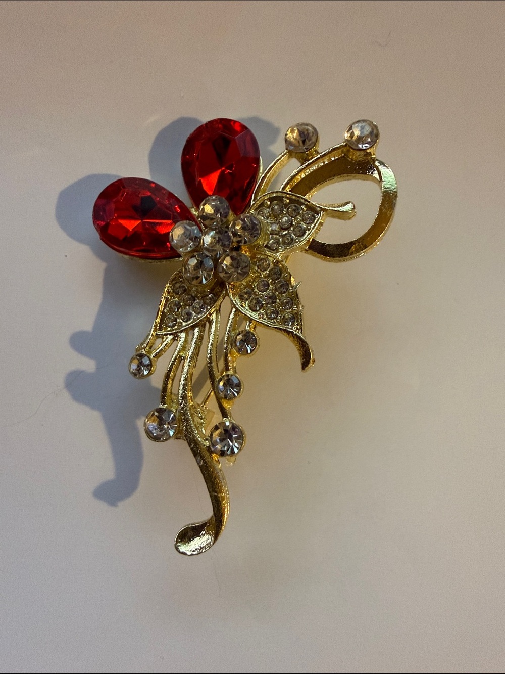 Gold Floral Statement Brooch with Red Gem Accents
